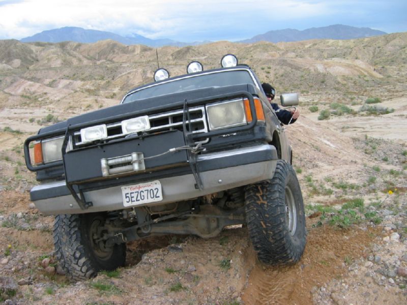 Black SUV with winch and light bar driving off-road