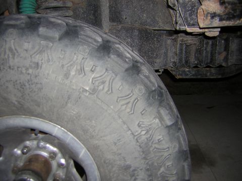 1995 Ford Bronco - Detail of a tire and suspension parts, not enough information to identify the vehicle.