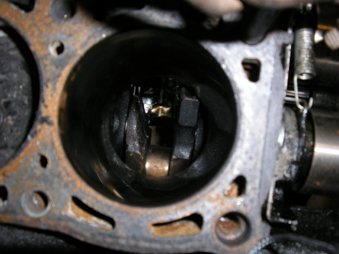 Close-up of an engine cylinder head with a visible cylinder bore