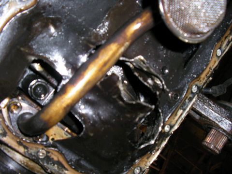 1990 Ford Probe - The oil pan and dipstick are visible in this close-up engine component shot.