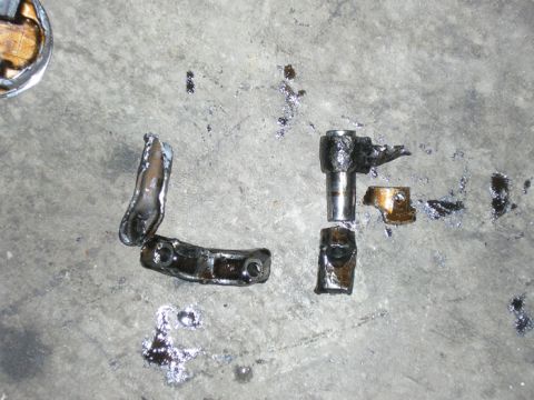 1990 Ford Probe - Various engine components are spread out on a gray, textured ground.