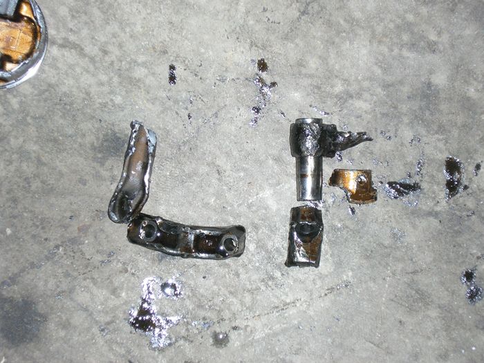 Scattered engine parts on a concrete surface