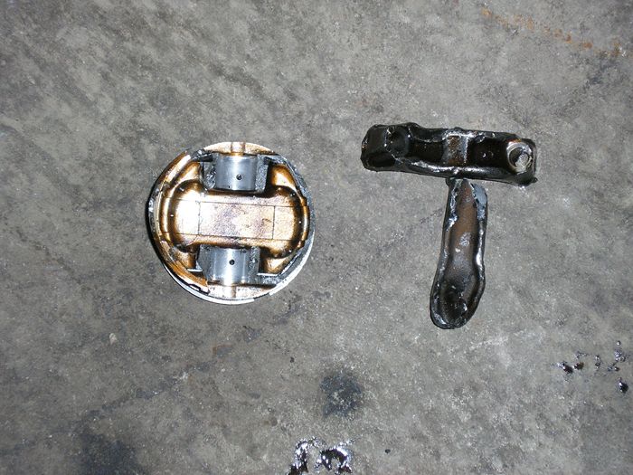 Piston and connecting rod on a concrete surface