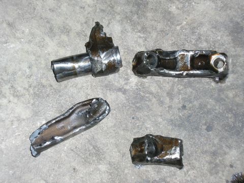 1990 Ford Probe - A collection of assorted engine components are displayed on a textured, metallic background.