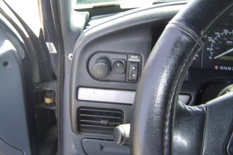 1993 Ford Bronco - The interior of a 1993 Ford Bronco shows the dashboard, steering wheel, and instrument cluster, with a 'Rear Window' control visible.