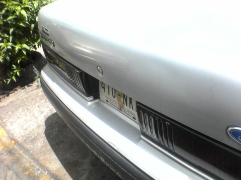 1991 Ford Taurus - Rear view of a silver sedan, showing the bumper and license plate.