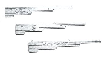 1978 Ford Mustang II - Three emblems: one with 'Ford', one with a horse, and one with 'MUSTANG'.