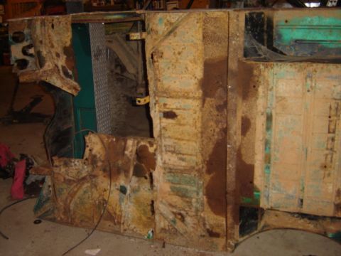 1992 Ford Bronco - This heavily rusted vehicle chassis shows significant deterioration, with some green interior panels still visible.