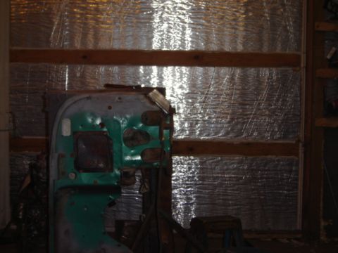 1992 Ford Bronco - A green metal panel with various cutouts is visible, likely a vehicle part in storage.