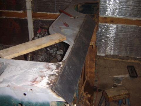1992 Ford Bronco - Car body panel and engine parts are visible in this workshop setting.