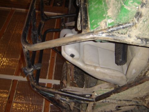 1992 Ford Bronco - Interior view of a modified off-road vehicle with a prominent roll cage and bucket seat.