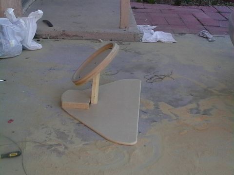 1999 Ford Taurus - A wooden steering wheel stand is shown on a concrete surface, with some debris and plastic bags nearby.