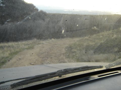 1991 Ford Bronco - Driving on a dirt road with a view of the landscape through the dusty windshield.
