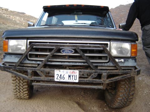 1991 Ford Bronco - Front view of a 1991 Ford Bronco equipped with a heavy-duty brush guard and off-road tires.