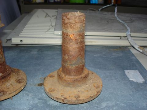 1987 Ford Bronco - Close-up of heavily rusted wheel hub assemblies, likely for an older vehicle.
