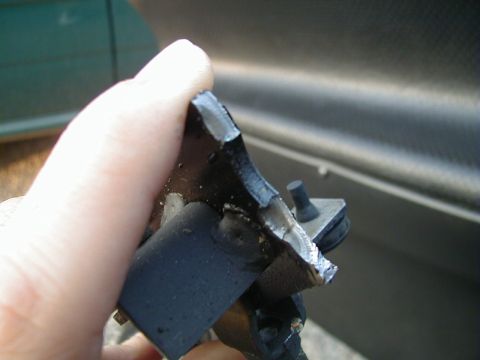 1993 Ford Probe - A damaged car part is held up for inspection against a vehicle's body.