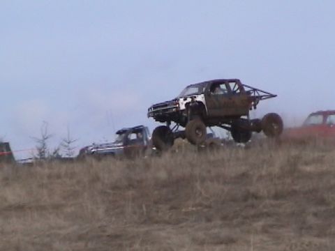 1994 Ford Explorer - A heavily modified pickup truck is captured mid-air during a mud fest event.