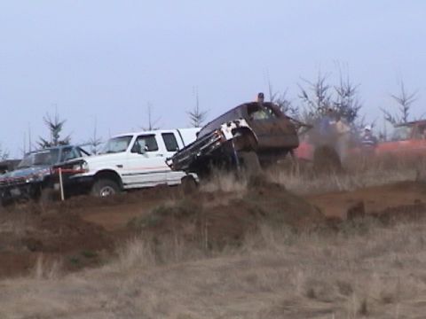 1994 Ford Explorer - Multiple off-road vehicles compete on a challenging muddy course during an event.