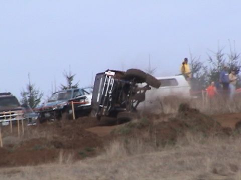 1994 Ford Explorer - An off-road vehicle has rolled over during an event, with spectators observing the scene.