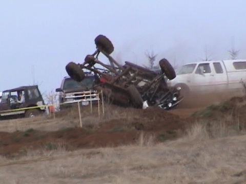 1994 Ford Explorer - An off-road vehicle has flipped onto its side during a mud festival event.