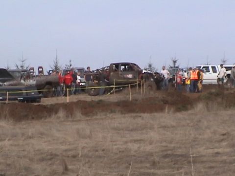 1994 Ford Explorer - Off-road vehicles participate in a mud bogging event with onlookers present.