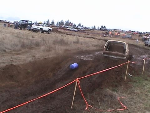 1994 Ford Explorer - SUV stuck in mud during an off-road event, with spectators and other vehicles present.