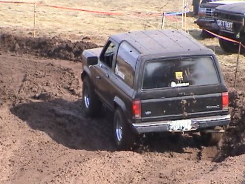 1994 Ford Explorer - This black Ford Bronco II navigates a muddy track during an event.