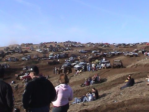 1994 Ford Explorer - Off-road event with numerous vehicles and people on a sunny day.