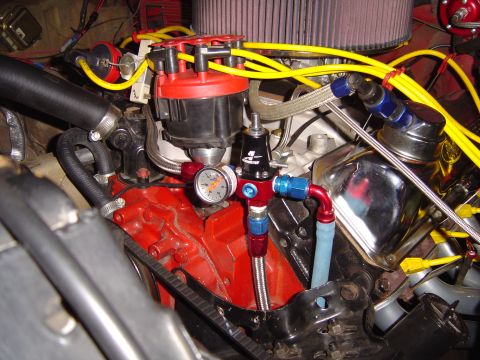 1978 Ford Bronco - Close-up of engine fuel system components, including a pressure regulator and gauge.