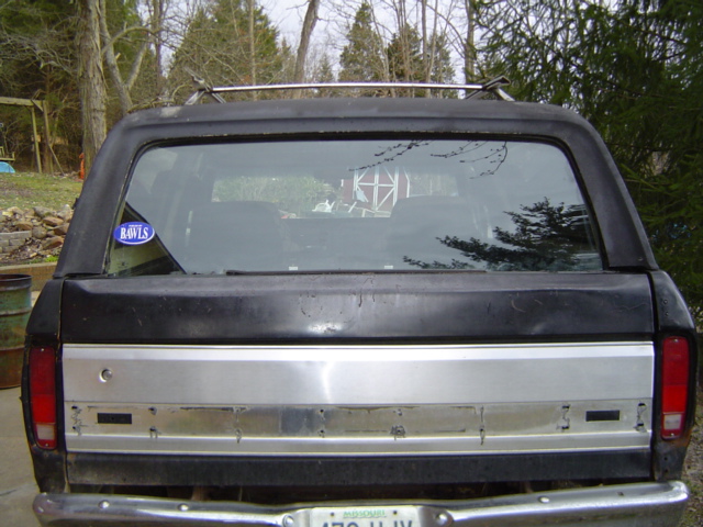Rear view of a black 1979 Ford Bronco with a silver tailgate accent