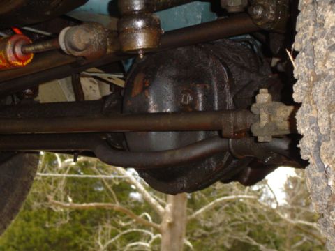 1979 Ford Bronco - Close-up of vehicle undercarriage, focusing on the differential and steering assembly.