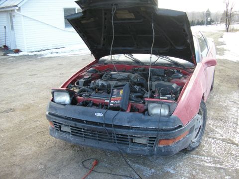 1990 Ford Probe - Front view of a 1990 Ford Probe with its hood open, revealing the engine.