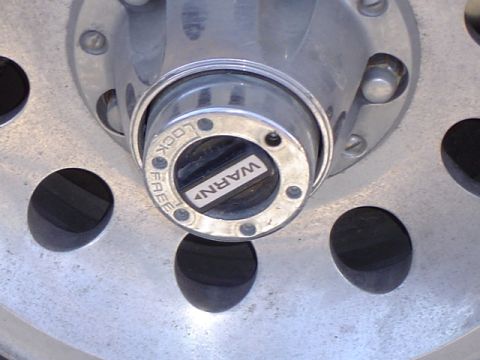 1979 Ford Bronco - Close-up of a vehicle's wheel hub, showing a Warn locking mechanism.