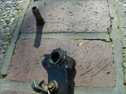 1993 Ford Probe - A disassembled car part rests on a brick walkway under bright sunlight.