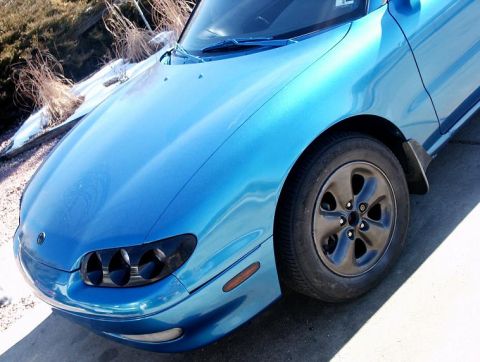 1993 Mazda MX-6 - Front quarter view of a blue 1993 Mazda MX-6 with black wheels.