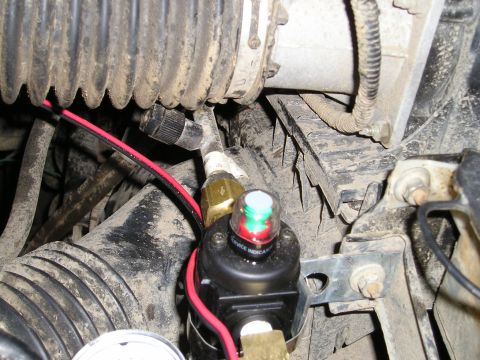 1996 Ford Bronco - Close-up of an on-board air compressor system, showing a service indicator light and various hoses.