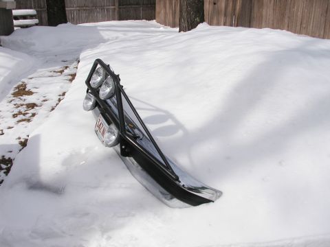 1994 Ford Bronco - Off-road light bar and bumper assembly covered in snow, with a license plate attached.