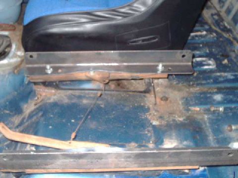 1984 Ford Bronco - Angle iron mounted to driver's-side seat brackets. I bent the middle up enough to clear the slide mechanism. Flat washers between the angle…