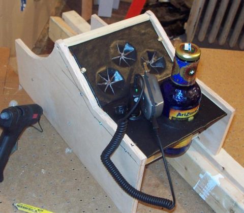 1985 Ford Crown Victoria LTD - A wooden console holds a bottle of Arizona iced tea and a device with a coiled cord.