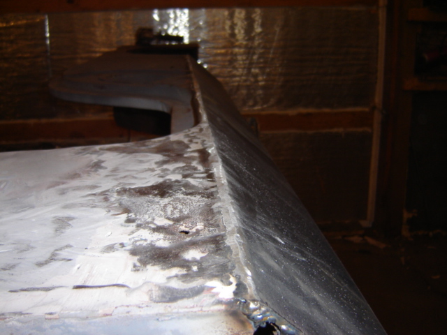 Close-up of welded metal edge, possibly from a vehicle repair