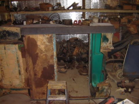 1992 Ford Bronco - Garage filled with parts and engines, suggesting a workshop or storage area.