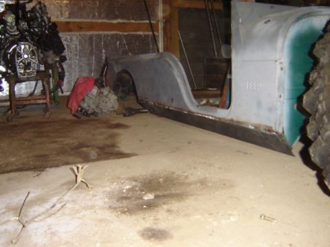 1992 Ford Bronco - Jeep CJ-6 body tub and engine are in a garage, possibly undergoing restoration.