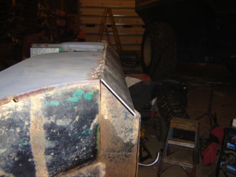 1992 Ford Bronco - Metalwork is underway on a vehicle's body panel in a workshop setting.
