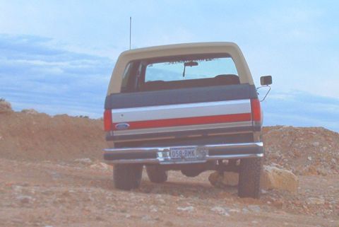 1989 Ford Bronco - This 1989 Ford Bronco displays its distinctive rear end with a two-tone paint scheme and prominent stripes.