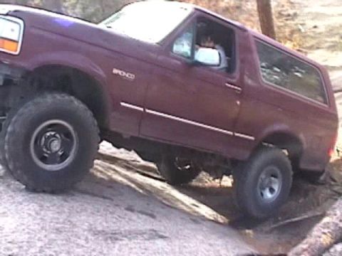 1993 Ford Bronco - This 1993 Ford Bronco is navigating a challenging off-road obstacle.