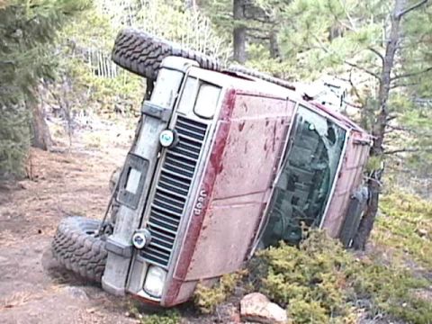 1993 Ford Bronco - This Jeep has rolled over in a wooded area, resting on its side.