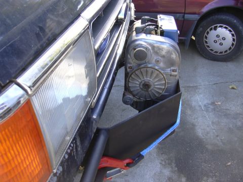 1991 Ford Bronco - A winch is mounted to the front bumper of a vehicle, with another vehicle visible in the background.