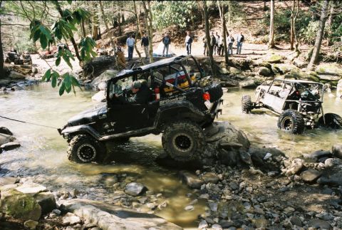 1990 Ford Bronco - Kentucky Krawler winching off a rock with an awesome buggy in the background.