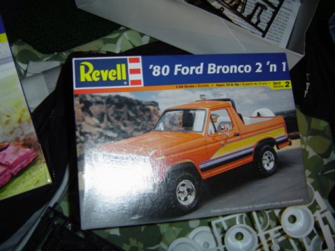 1979 Ford Bronco - Box art for a Revell '80 Ford Bronco 2 'n 1 model kit, showing an orange Bronco with racing stripes.