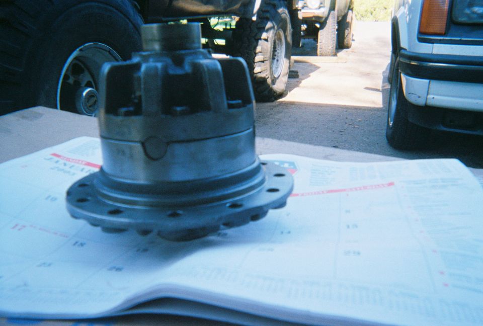Differential carrier sitting on a calendar page with vehicles in the background